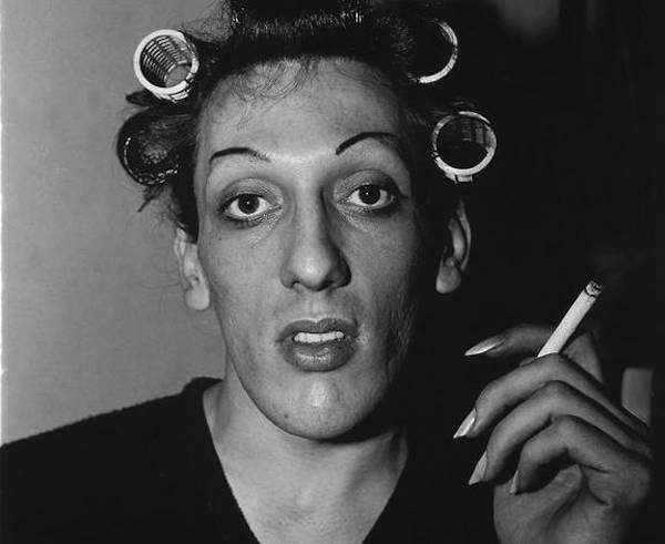 Young man in curlers at home on West 20th Street (1966) by Diane Arbus