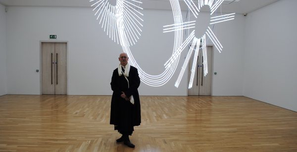 Cerith Wyn Evans with ‘Radiant fold (….the Illuminating Gas)’, 2017/18, National Museum Cardiff. Photo: P A Black © 2018