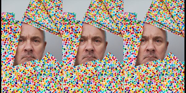 Damien Hirst with The Currency artworks, 2021. Photographed by Prudence Cuming Associates Ltd. © Damien Hirst and Science Ltd. All rights reserved, DACS 2022