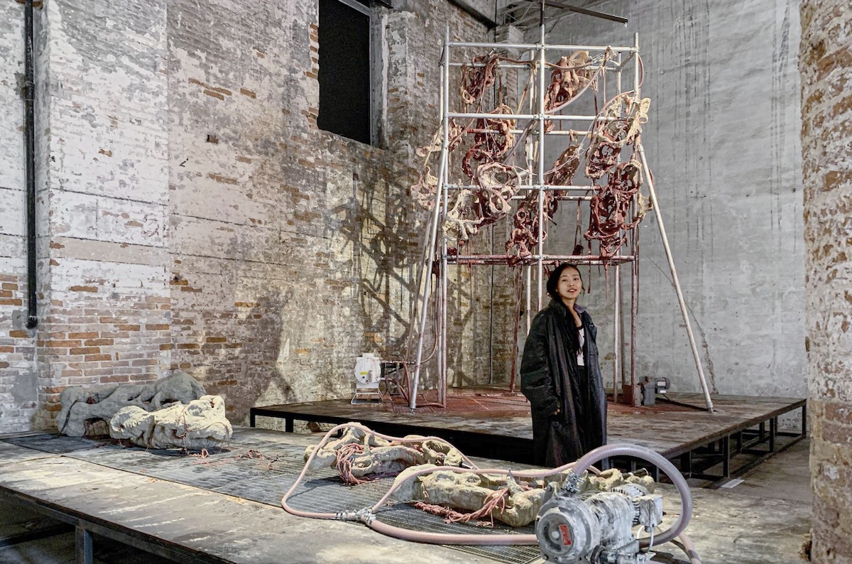 Artist Mire Lee poses in front of “Endless House: Holes and Drips” (2022), now on view at the 59th Venice Biennale's ″The Milk of Dreams.″ [TINA KIM GALLERY]