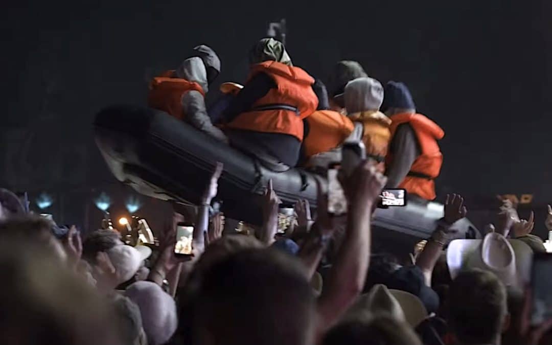 Banksy Revealed As Mastermind Behind Inflatable Migrant Boat At Glasto