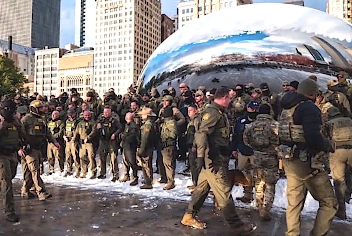 Border Patrol agents pose for photos next to Anish Kapoor’s Cloud Gate sculpture in Chicago. Photograph: Facebook