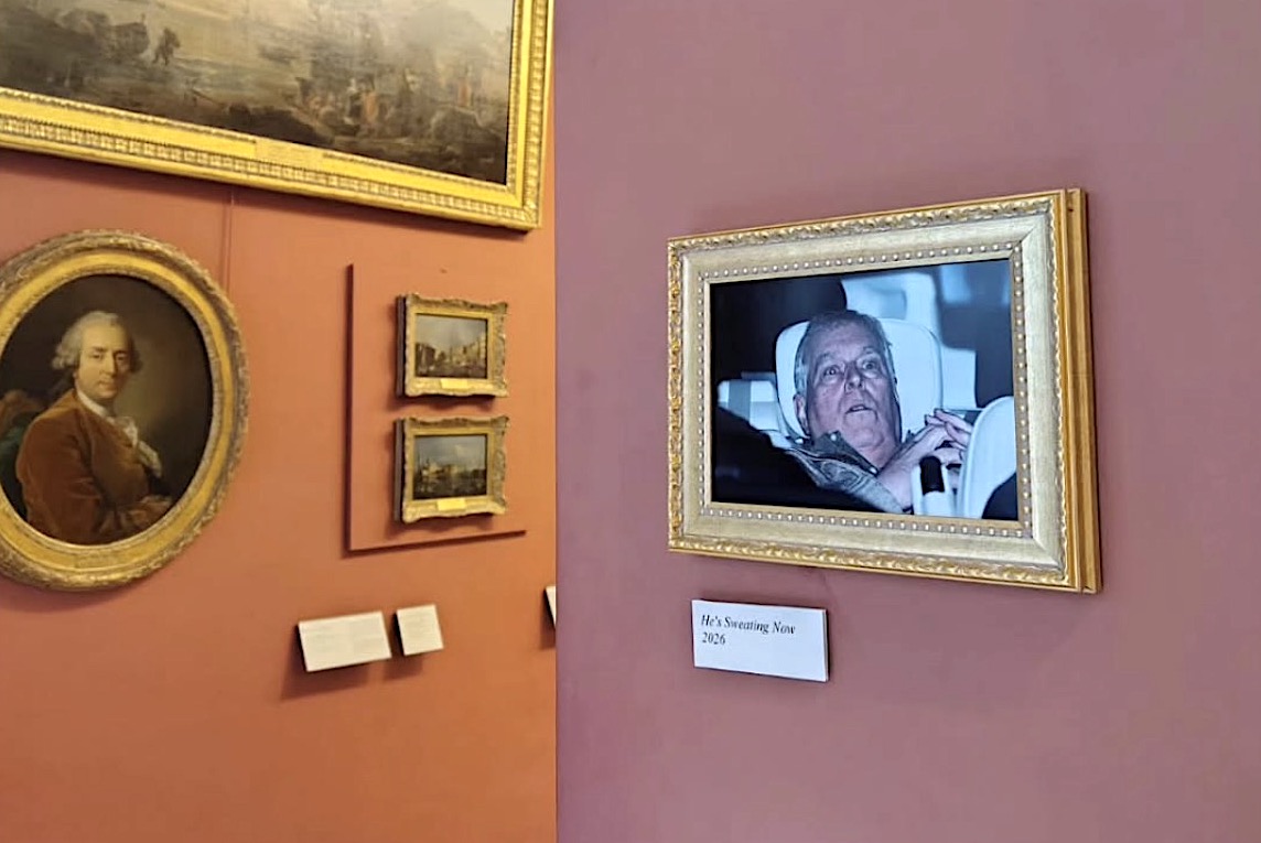 Activists staged an art intervention at the Louvre Museum in Paris yesterday by installing the now-iconic photograph of Andrew Mountbatten-Windsor being driven from a police station after his arrest.
