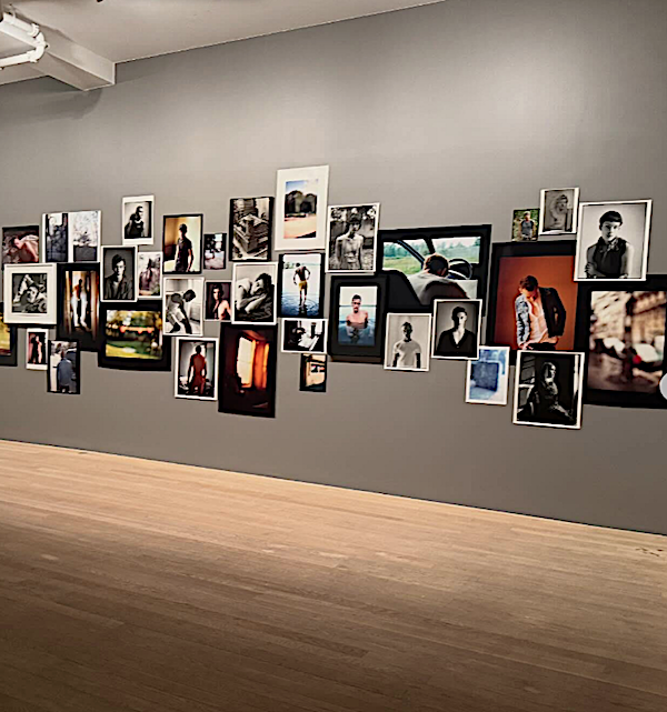 David Armstrong, Jefferson Avenue, Brooklyn, 1997, Cibachrome© David Armstrong. Courtesy of the Estate of David Armstrong [An out-of-focus photograph of a wooden chair in a golden-lit room decorated with curtains, a carpet, and a framed artwork leaning against the back wall.]