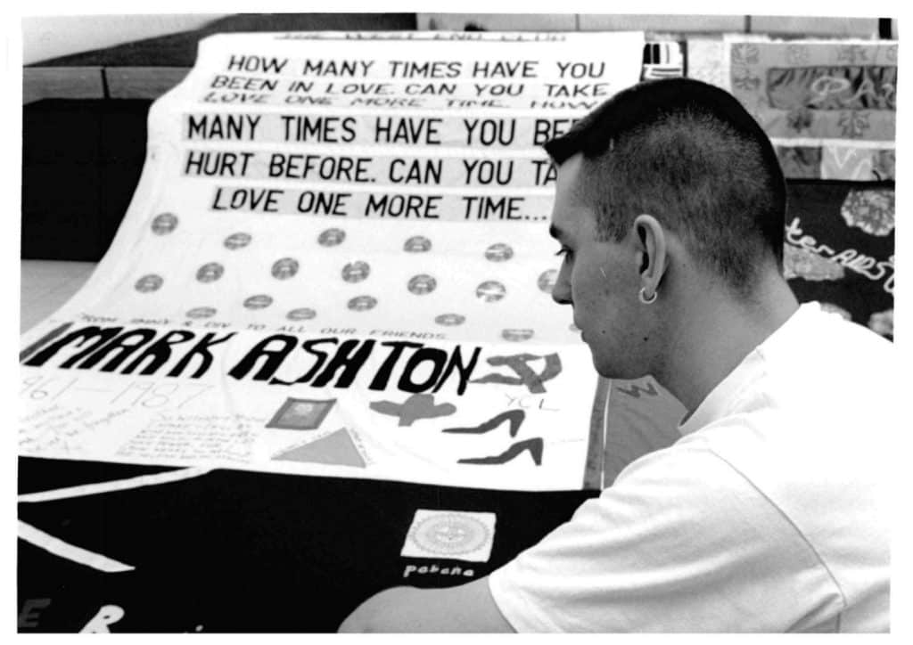 Archive image of Ally Van Tillo with the UK AIDS Memorial Quilt – Image courtesy of Waverley Care
